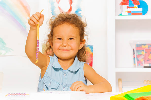 istock Happy little girl with beads on a string 480865482