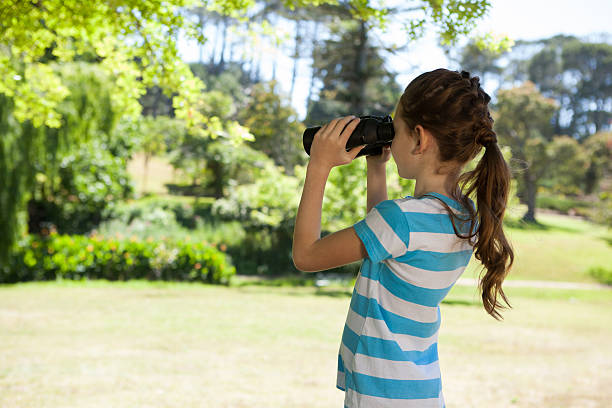 istock Cute little girl looking through binoculars 480865498