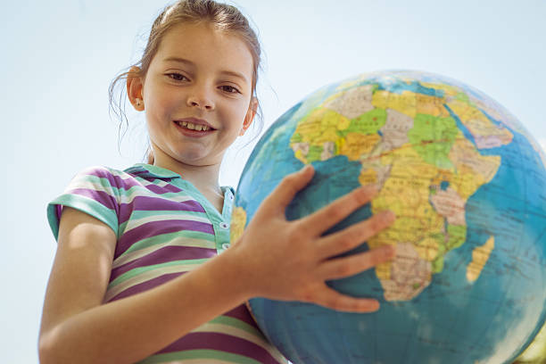 istock Cute little girl holding globe 480865560