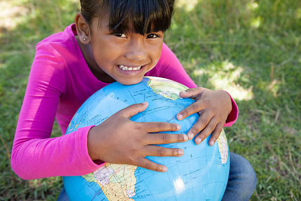 istock Cute little girl holding globe 480866536
