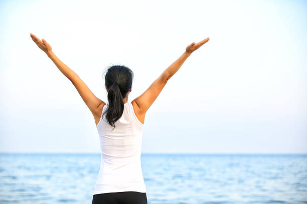 cheering woman open arms at seaside, summer holidays