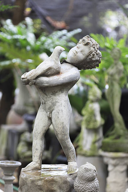 istock Cupid Statue sculpture in the garden. 480871582