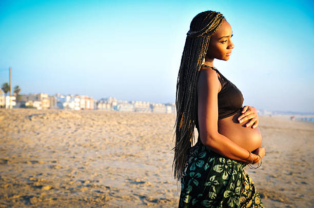 Pregnant woman on beach stock photo
