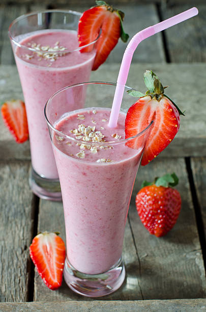 istock Strawberry smoothie on a wooden table 480875635