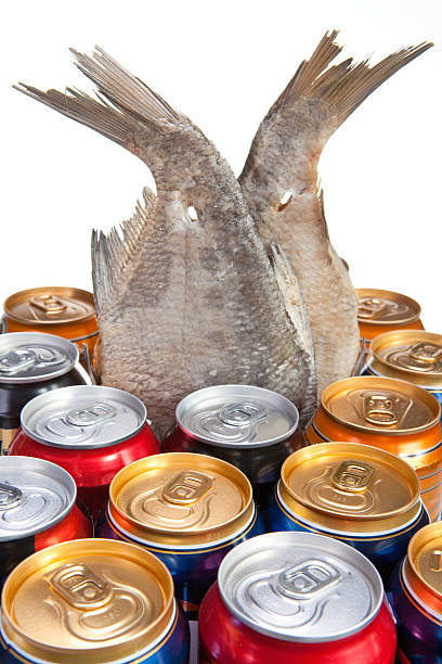 Dried fish and beer on a white background
