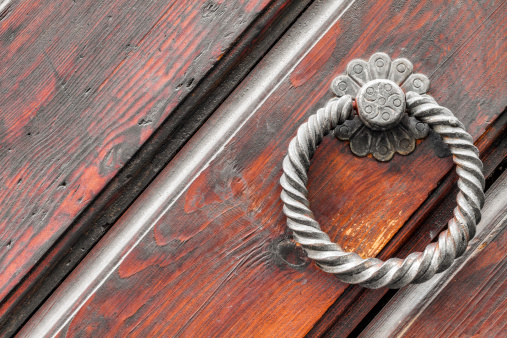 Vintage doorknob on antique door, background