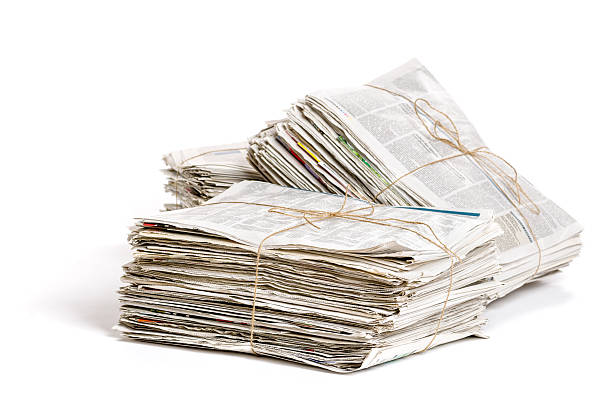 alguns pacotes de jornais em um fundo branco - recycling paper newspaper garbage - fotografias e filmes do acervo