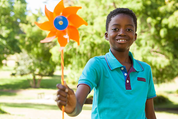 istock Happy boy in the park with pinwheel 480877180