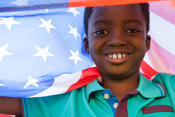 istock Happy boy in the park with american flag 480877182