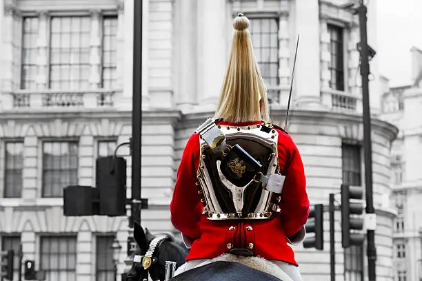 A Royal Horse Guards soldier in traditional uniform sitting on horseback during horse guards parade in London, England, the UK.