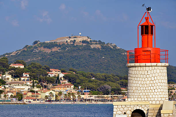 Lighthouse with red lantern in the port of Sanary-sur-Mer, commune in the Var department in the Provence-Alpes-Côte d'Azur region in southeastern France.