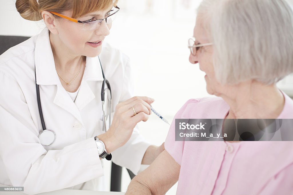 Receives an injection of insulin Senior woman receives an injection of insulin Adult Stock Photo