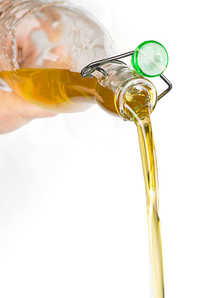 Pouring olive oil Pouring olive oil  high quality studio photo shoot olive oil pouring antioxidant liquid stock pictures, royalty-free photos & images