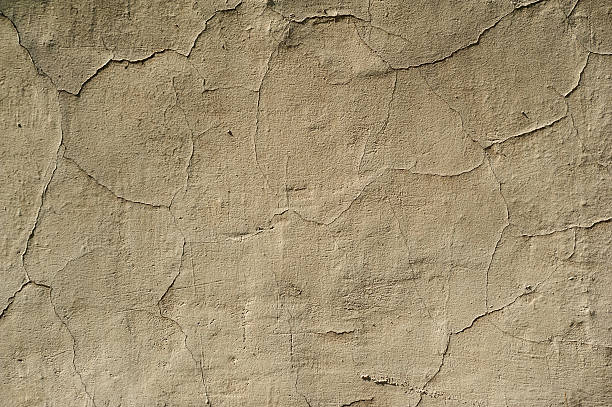 istock Texture of old wall covered with yellow stucco 480884724