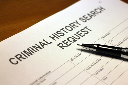 Someone filling out Criminal History Search Request.