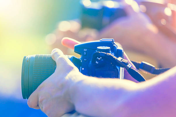istock photographers holding digital photo camera 480888460