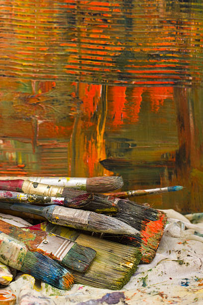 istock Paintbrushes on abstract painted canvas. Oil paints, colorful background. 480888698