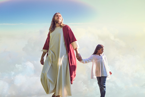 Jesus Christ walks with a child among the clouds on their way to heaven.