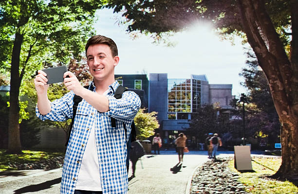 istock Smiling male student taking a selfie in university 480893576