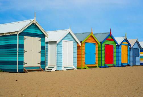 A colorful summer photo of historical beach houses in Melbourne, Australia.