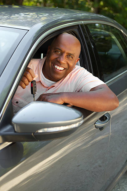 istock Man holding a key to his new car 480894436