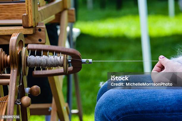 Closeup Spinning Yarn On A Wheel Stock Photo - Download Image Now - Spindle, Wool, Knitting