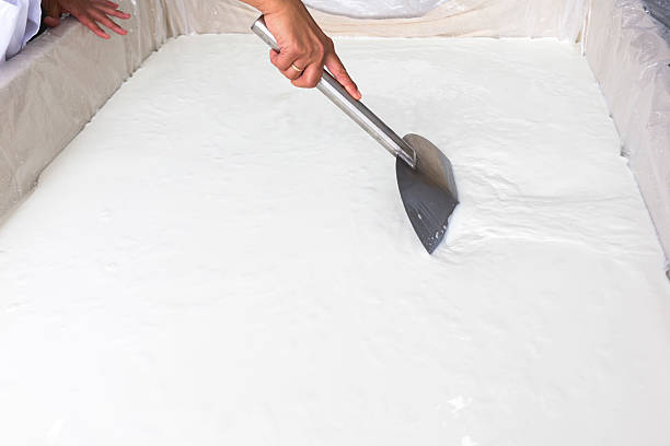 istock Cheese production creamery dairy worker mixing 480897920