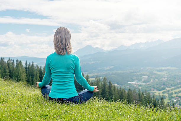 istock Woman Meditate at the Mountains 480903786