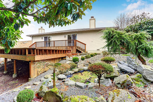 istock beautiful back deck with lush plants and pond. 480903942