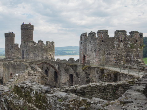 Сonwy, Wales - September 28, 2013: View on the battlements of massive Conwy Castle in Wales built by king Edward I as one of the fortifications during the conquest of Wales in the 13th Century