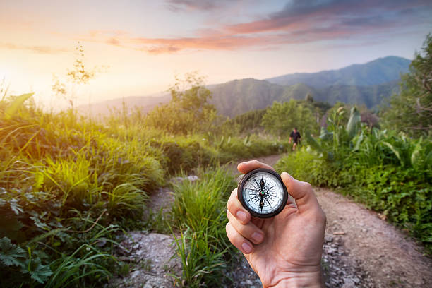 Hand with Compass in the mountains Hand with compass at mountain road at sunset sky in Kazakhstan, central Asia almaty photos stock pictures, royalty-free photos & images