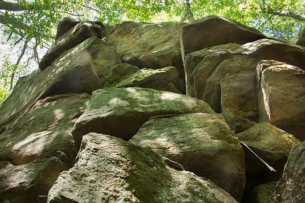 Looking up at a crumbling rock cliff of gneiss in Chatfield Hollow State Park in Killingworth, Connecticut.