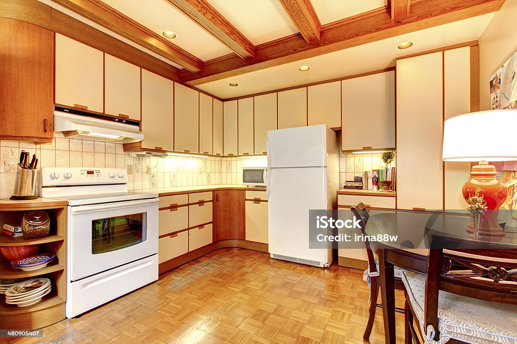 Old simple white and wood kitchen interior. Old simple white and wood kitchen interior with hardwood floor. Apartment Stock Photo