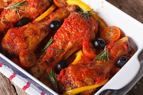 istock Chicken legs in sauce on baking dish closeup top view 480907140
