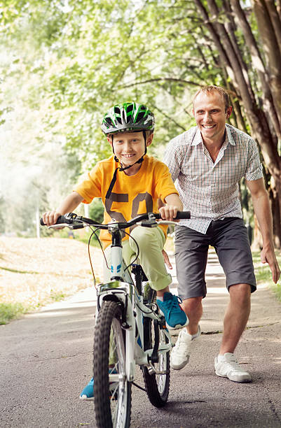 istock Little boy learn to ride bicycle with his father 480907346