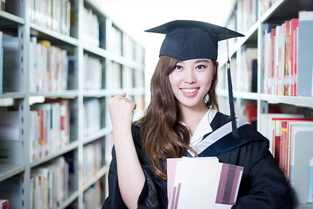 istock asian beautiful female student holding book in library portrait 480907700
