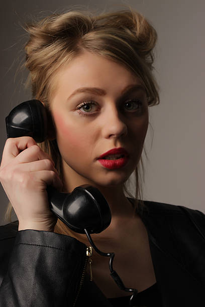 istock young cute blond girl with an old handset 480908032