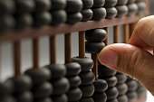 Man hands are operating abacus