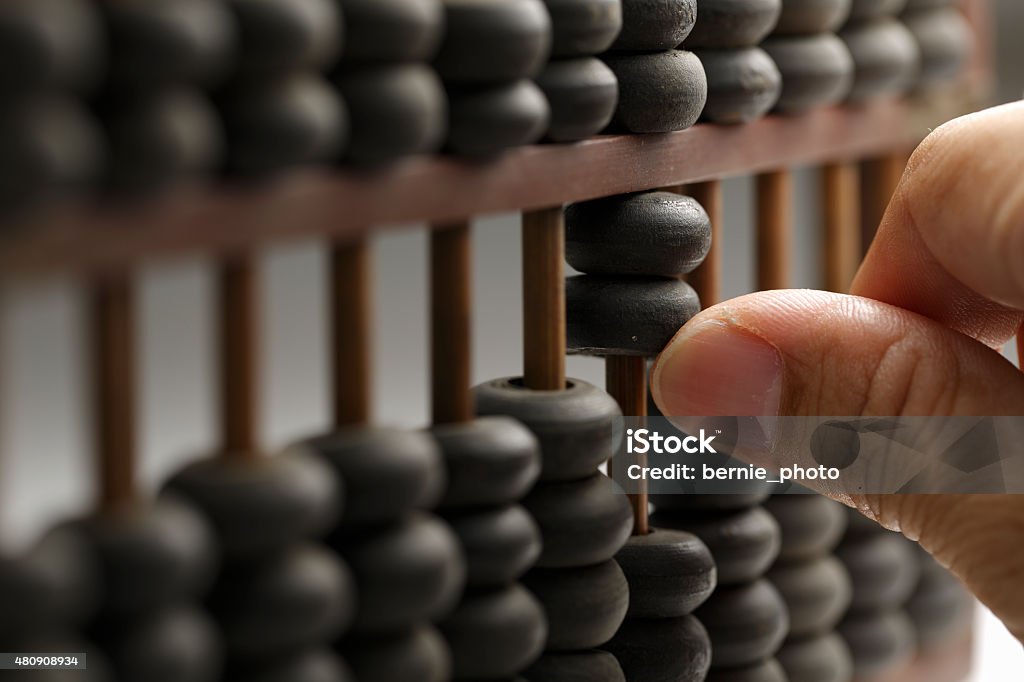Man hands are operating abacus Old wooden abacus with a calculated Abacus Stock Photo