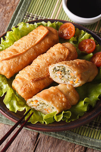 istock Cut spring rolls fried with sauce closeup vertical, top view 480909776