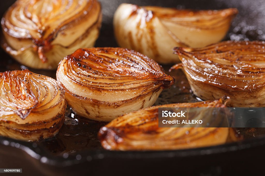 ñaramelized onion halves with balsamic vinegar in a pan ñaramelized onion halves with balsamic vinegar in a pan close-up, horizontal Onion Stock Photo