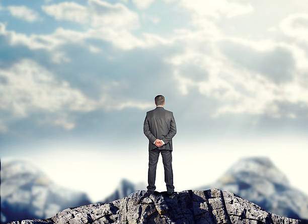 istock Businessman standing on mountain top 480909946