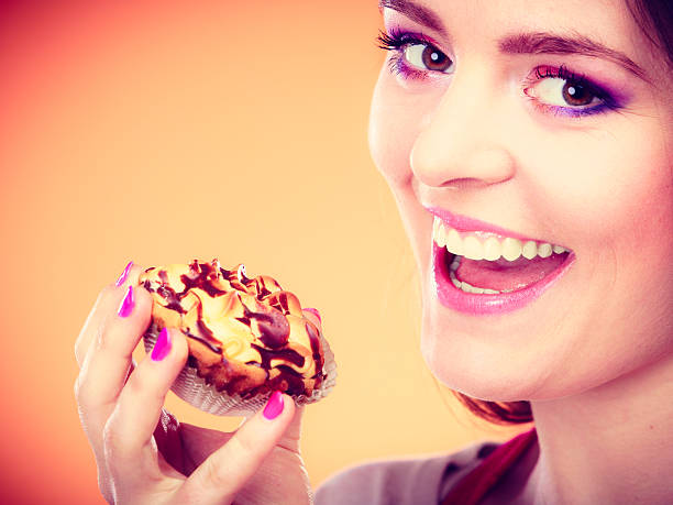 istock Smiling woman holds cake in hand 480910468