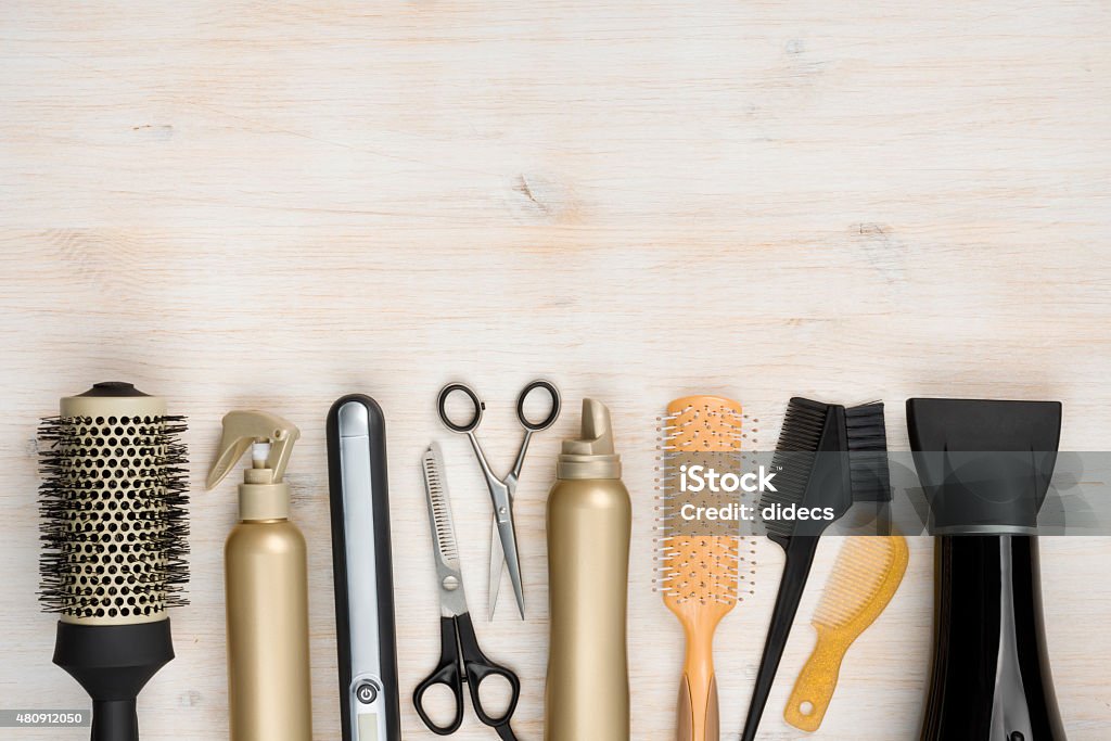 Hairdressing tools on wooden background with copy space at top Hair Salon Stock Photo