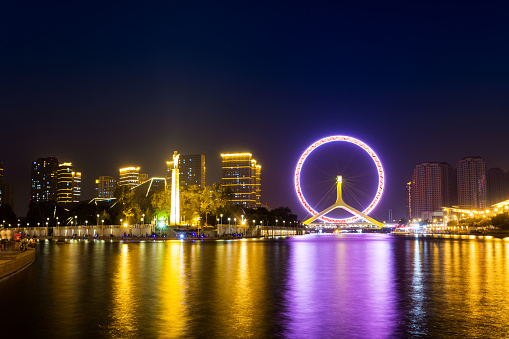 Illuminated skyline and cityscape at riverbank