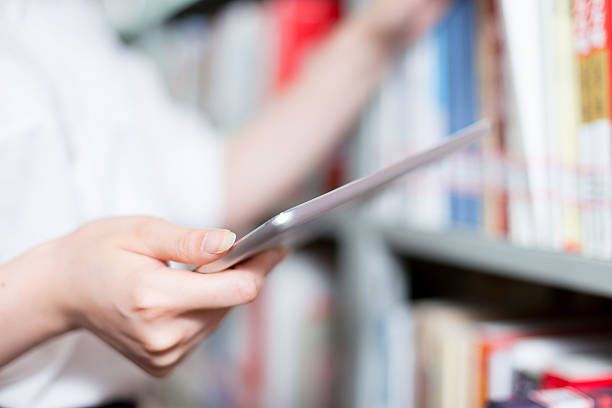 istock close up of hand touching tablet in library 480920160