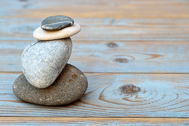 istock Grey cairn zen stones on blue old wooden empty background 480920498