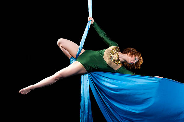 istock Young gymnast doing exercise on aerial silks 480920716