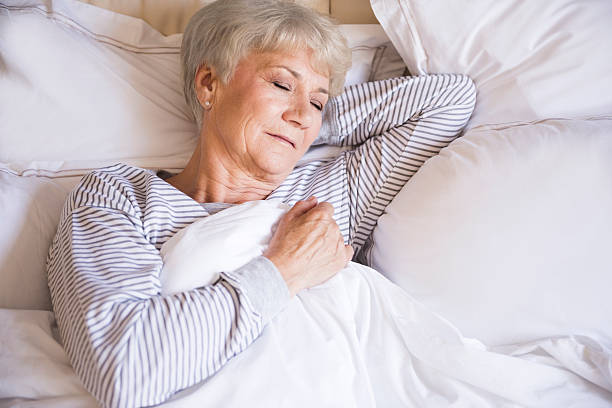 istock Tired senior woman sleeping in bed 480921442