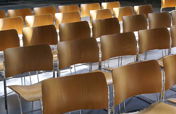 istock rows of wooden chairs 480921828